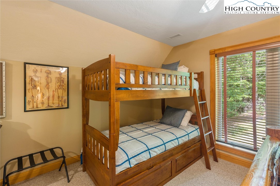 411 West Ridge Drive Ferguson, NC 28624 - Photo 32 of 45 a bedroom with a bunk bed and a window