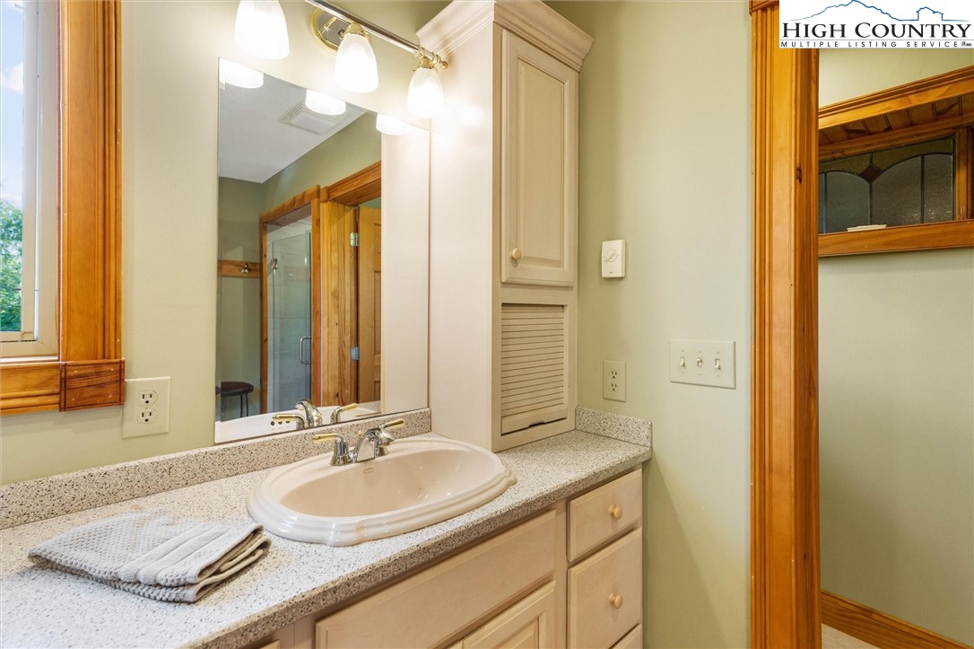411 West Ridge Drive Ferguson, NC 28624 - Photo 38 of 45 a bathroom with a granite countertop sink and a mirror