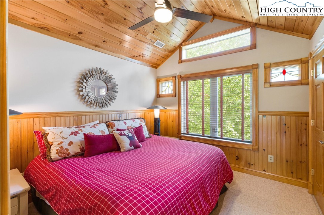 411 West Ridge Drive Ferguson, NC 28624 - Photo 39 of 45 a bedroom with a large bed and a chandelier