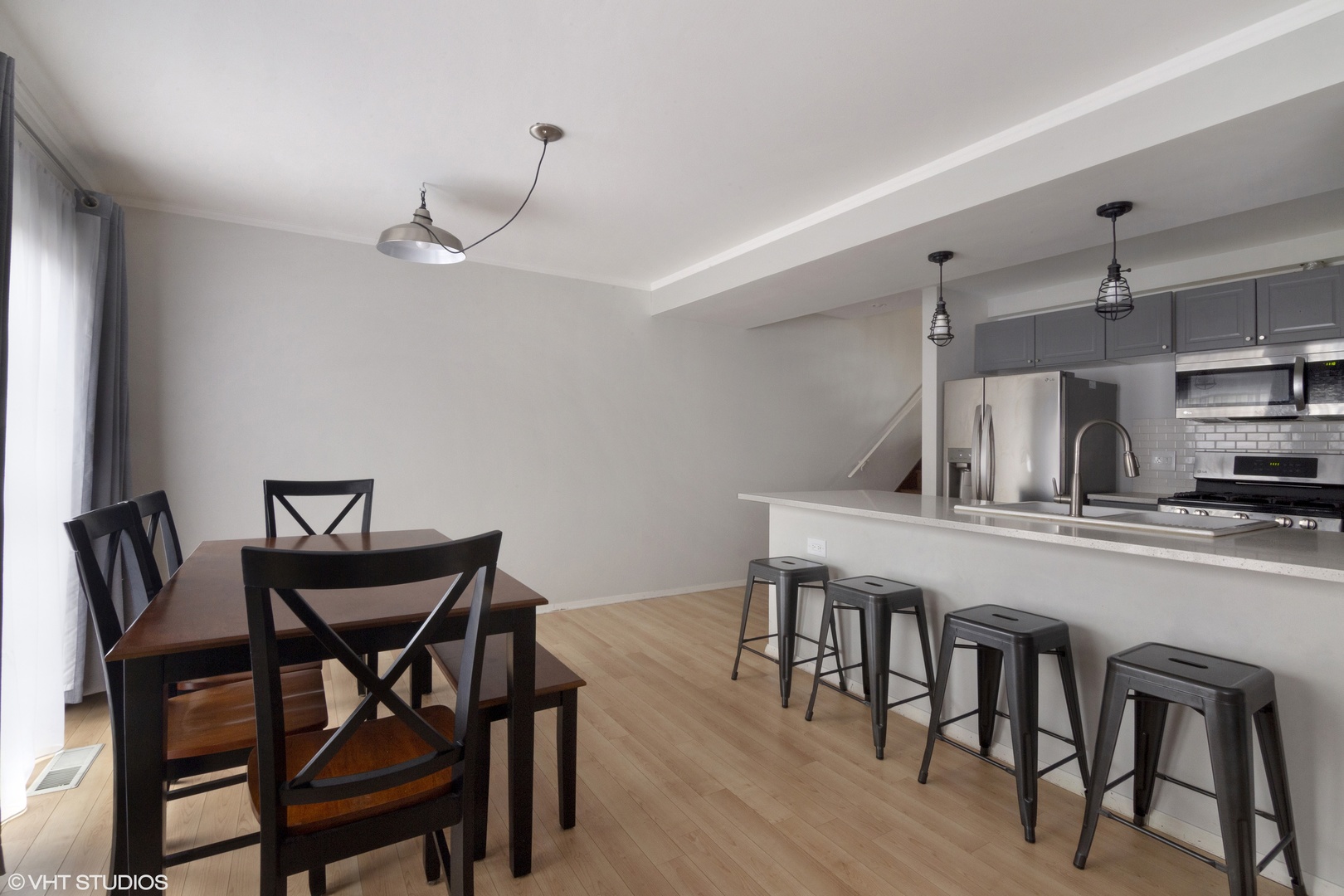 649 Spring Road Glenview, IL 60025 - Photo 5 of 16 a kitchen with stainless steel appliances a table and chairs in it