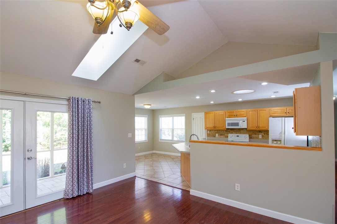 735 Britton Street Anderson, SC 29621 - Photo 13 of 50 This bright interior features wood flooring, vaulted ceilings, and a well-appointed kitchen.