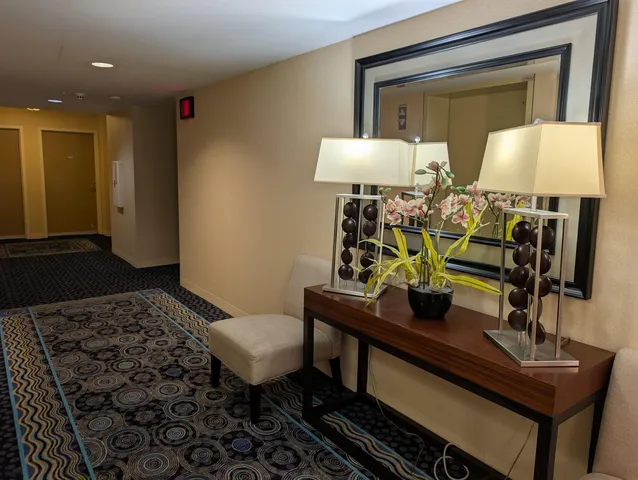 a living room with furniture and a lamp