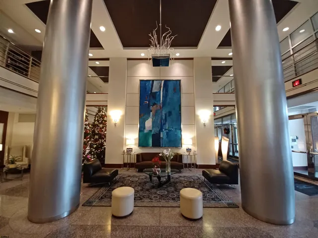 a very nice looking room with a large mirror and chandelier