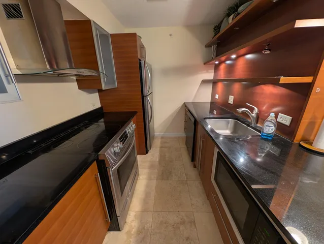 a kitchen with a sink and stove