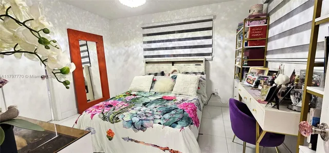 a bed room with a bed and a chair