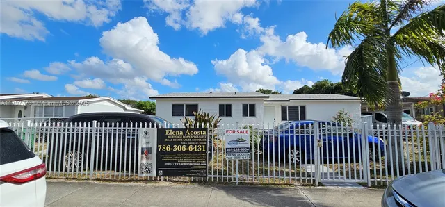 a view of a house with a wooden deck