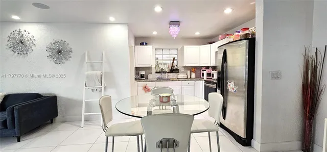 a view of a dining room with furniture and a chandelier