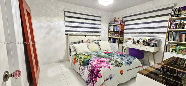 a bedroom with bed and a window