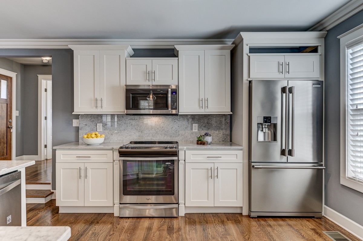 815 Lischey Avenue Nashville, TN 37207 - Photo 11 of 34 a kitchen with white cabinets and stainless steel appliances