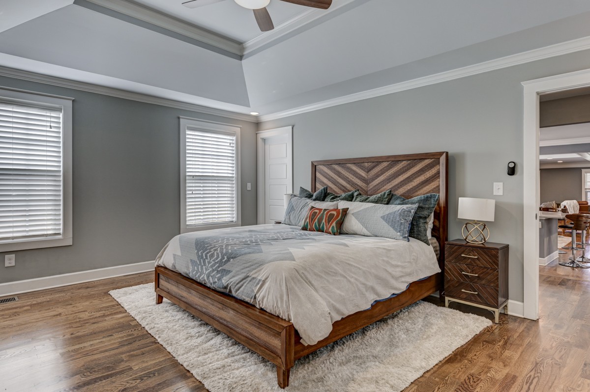 815 Lischey Avenue Nashville, TN 37207 - Photo 17 of 34 a large bed sitting in a bedroom next to a window and a lamp