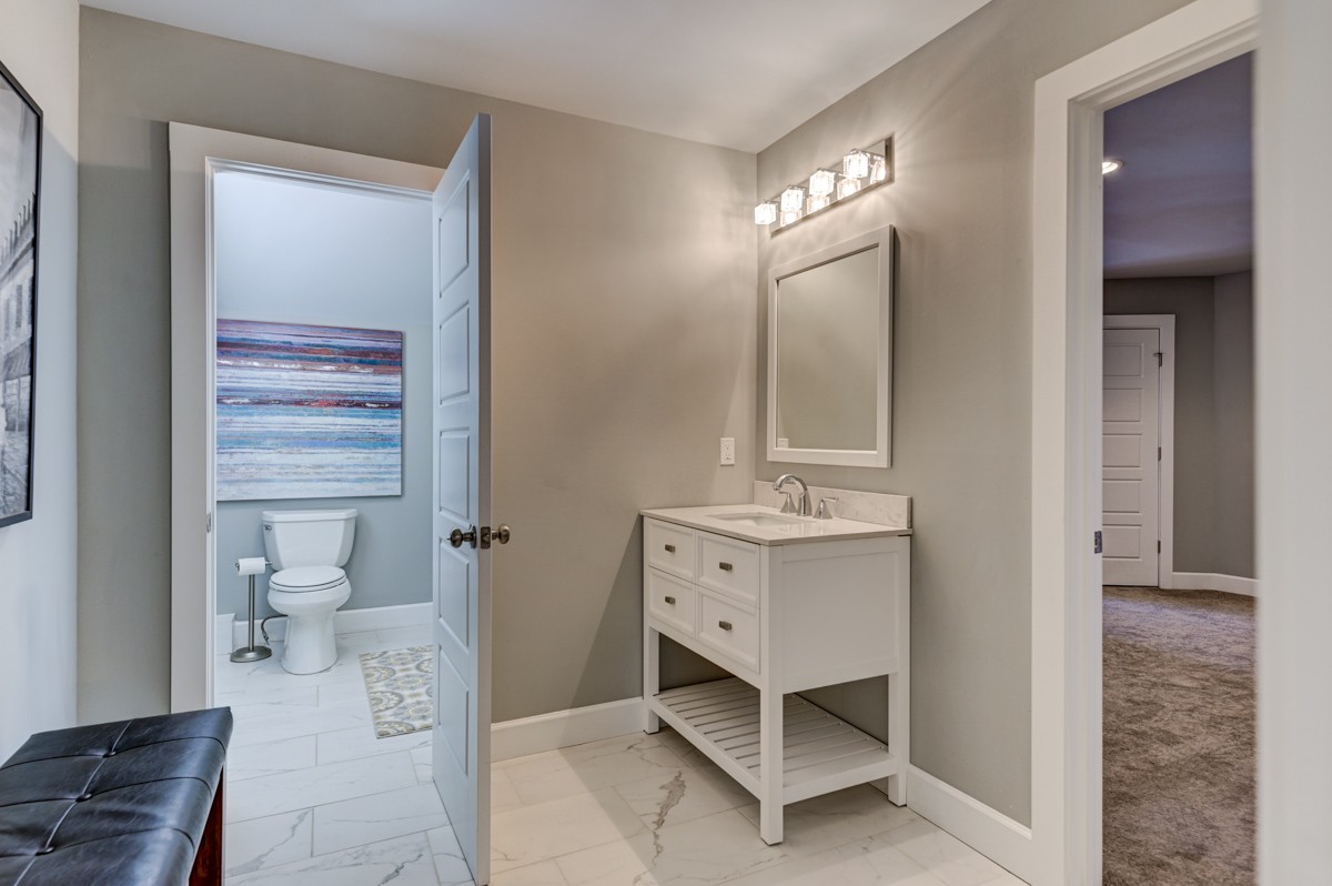 815 Lischey Avenue Nashville, TN 37207 - Photo 26 of 34 a spacious bathroom with a toilet sink and mirror