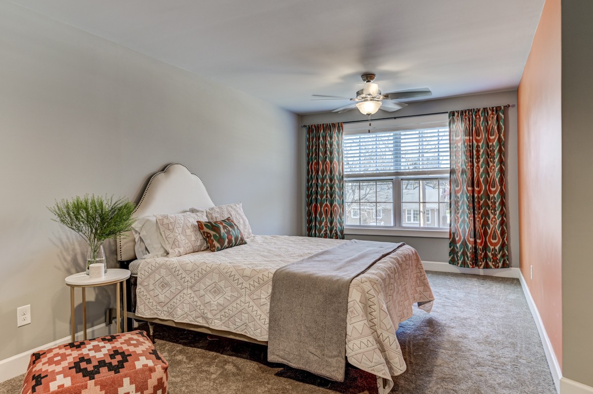 815 Lischey Avenue Nashville, TN 37207 - Photo 28 of 34 a bedroom with a large bed and a chandelier