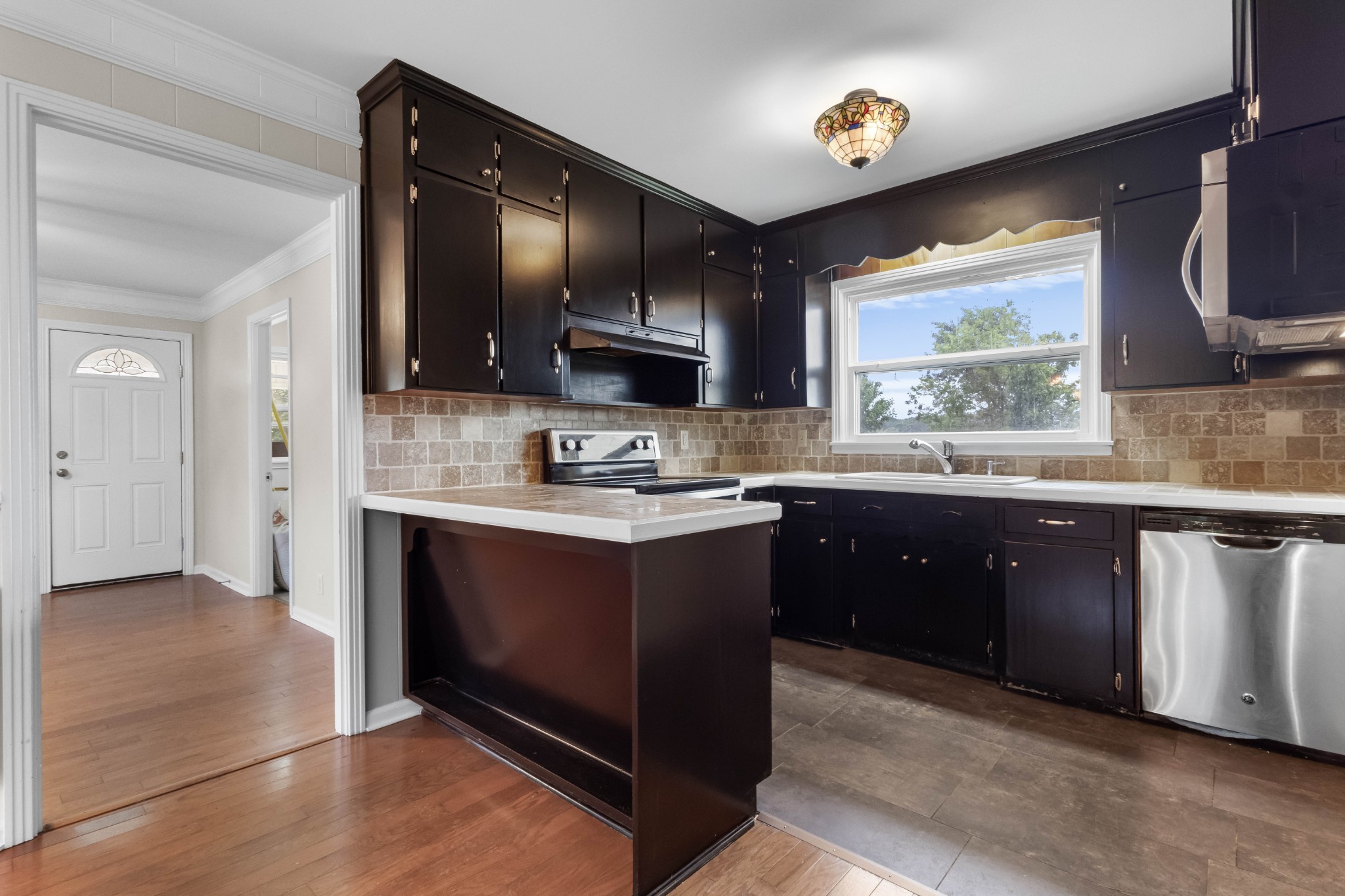 3070 Dover Road Woodlawn, TN 37191 - Photo 12 of 32 a kitchen with stainless steel appliances granite countertop a sink stove and cabinets