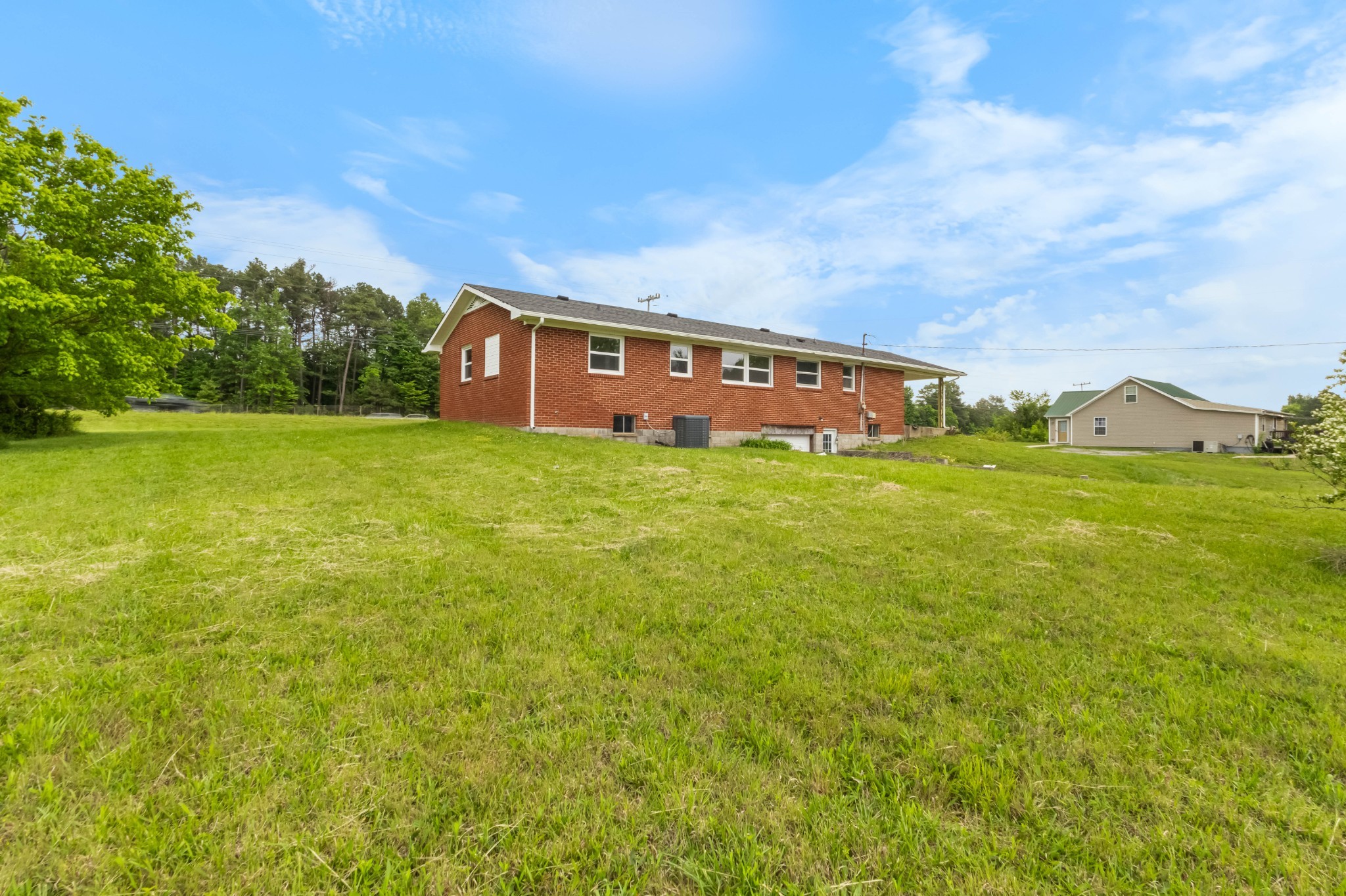 3070 Dover Road Woodlawn, TN 37191 - Photo 26 of 32 a view of a big house with a big yard and large trees
