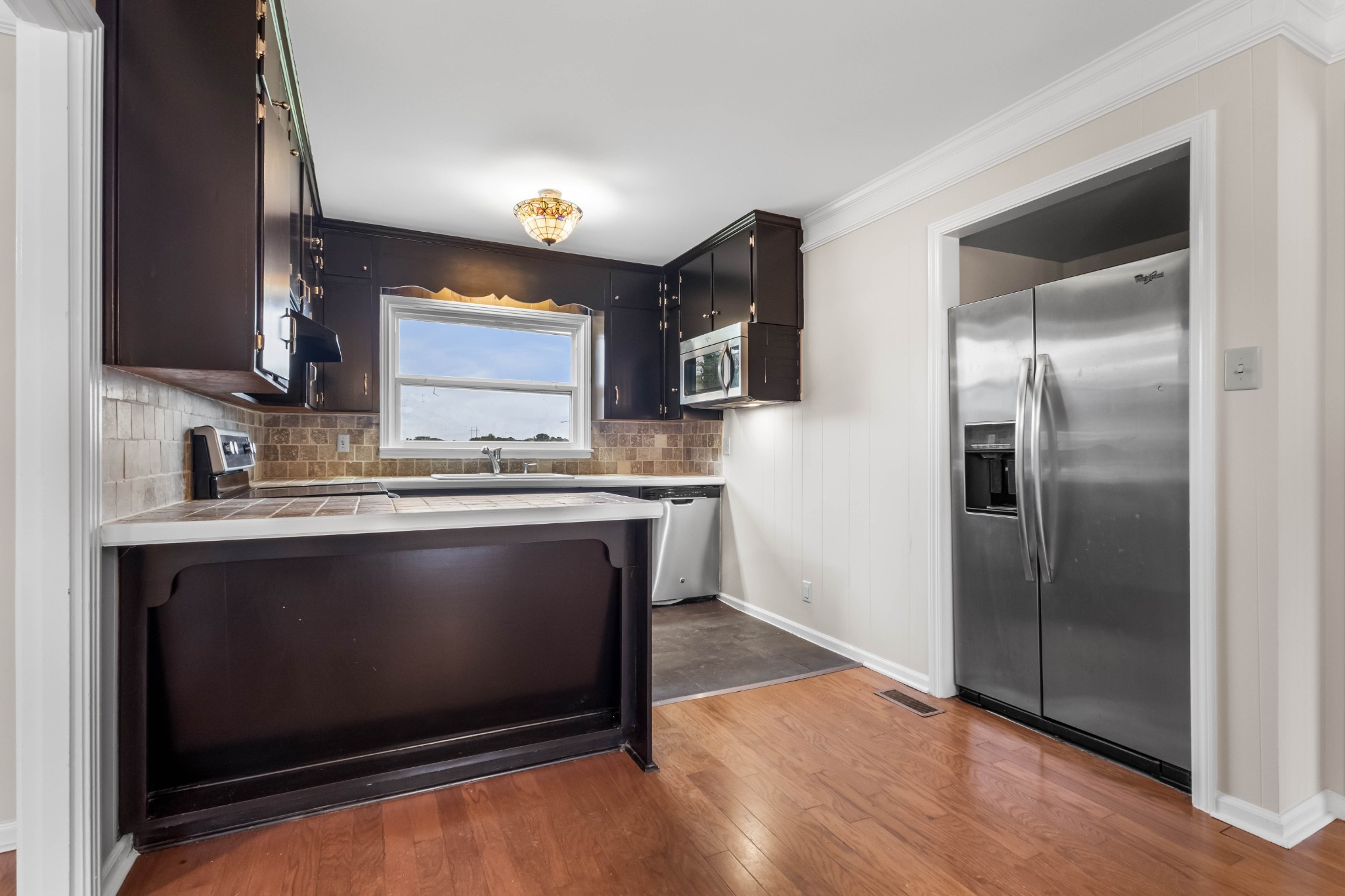 3070 Dover Road Woodlawn, TN 37191 - Photo 10 of 32 a kitchen with granite countertop a refrigerator stove and sink