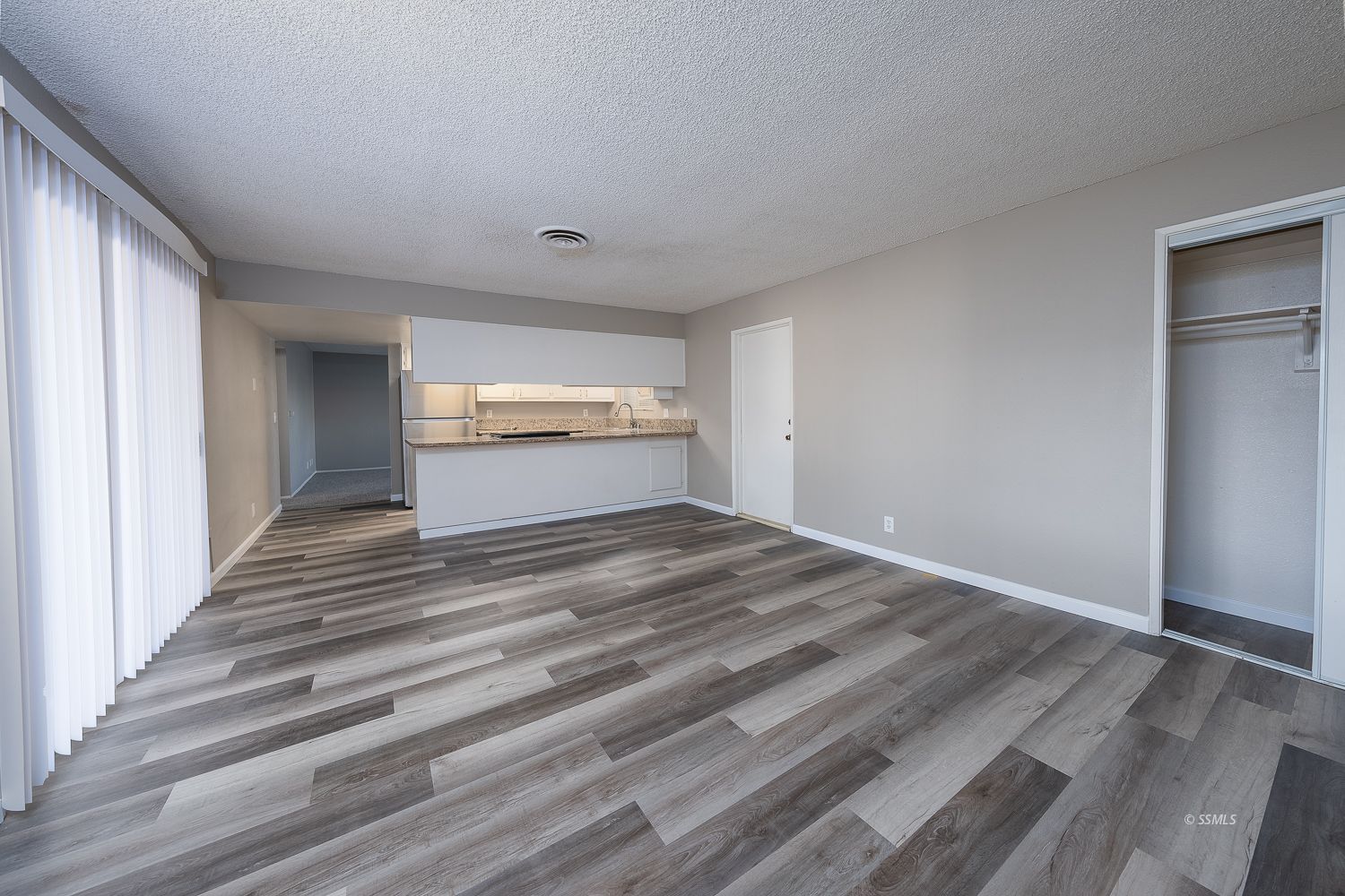 609 West Joyner Avenue Ridgecrest, CA 93555 - Photo 9 of 29 a view of wooden floor and windows in a room