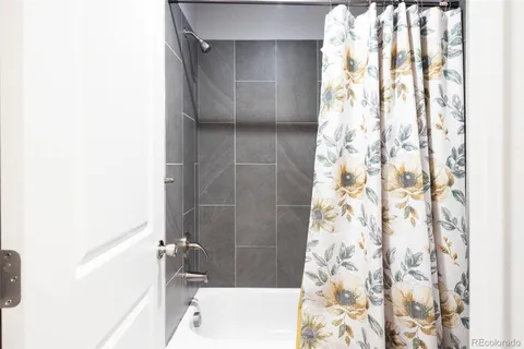 a bathroom with a bathtub and shower