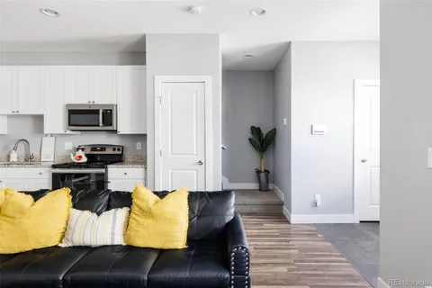 a kitchen with a refrigerator and a stove top oven