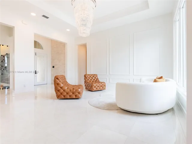 a view of a dining room with furniture and a large window