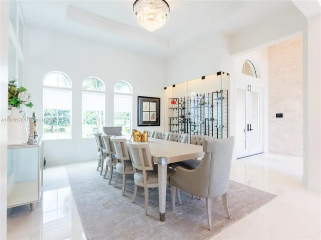 a view of a living room with a white kitchen