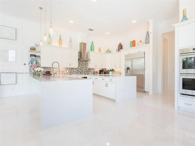 a bathroom with a white tub sink and mirror