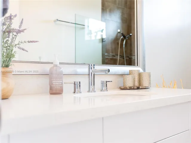 a living room with furniture flat screen tv and a large window
