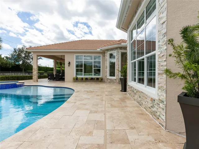 a view of a patio with table and chairs potted plants with wooden fence