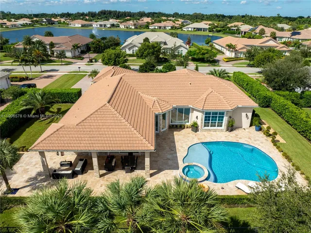 an aerial view of a house with yard swimming pool and outdoor seating