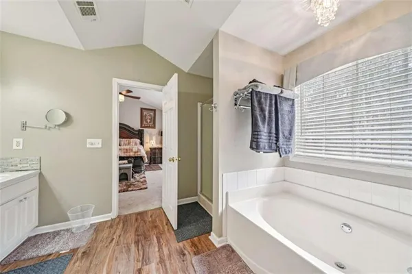 a view of walk in closet with clothes