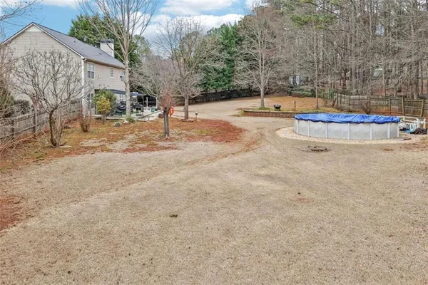 a view of a yard with large tree