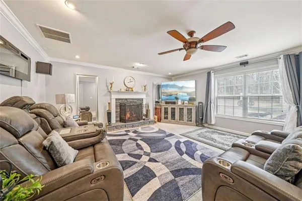 a living room with furniture large window and a fireplace