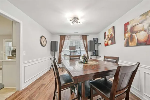 a view of a dining room with furniture wooden floor and chandelier