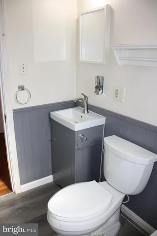 a white toilet sitting next to a bathroom sink