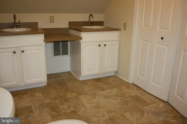 a view of a kitchen that has a sink and cabinets