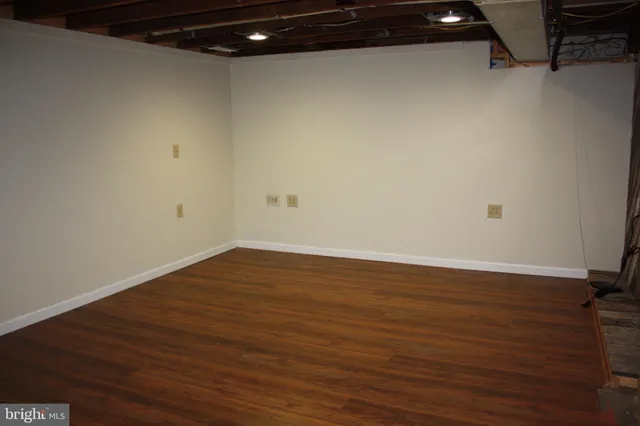 a view of a room with wooden floor