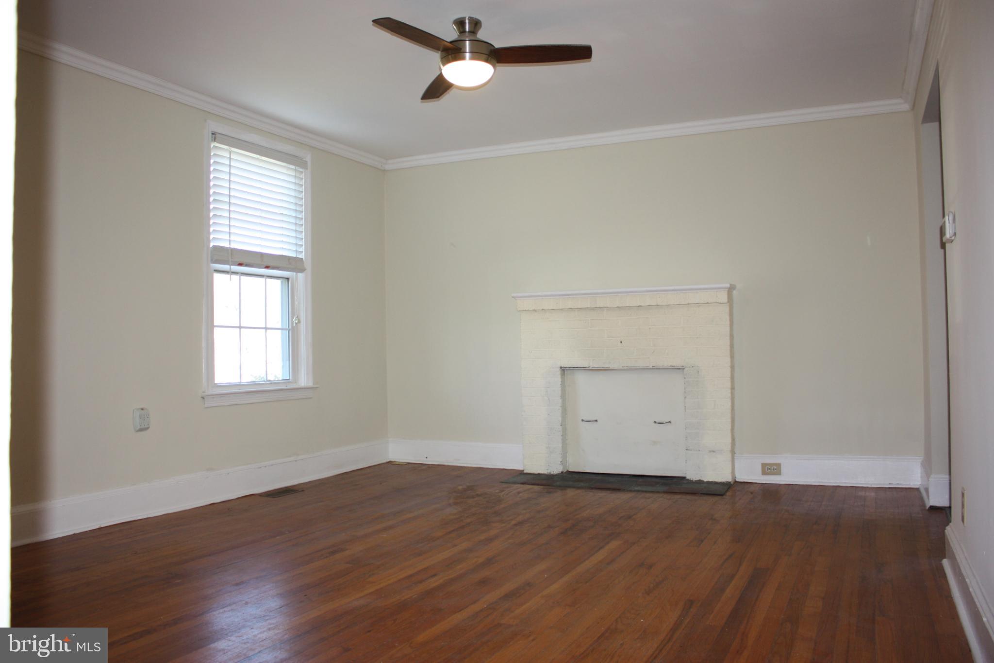 423 Happy Creek Road Front Royal, VA 22630 - Photo 6 of 48 an empty room with a window and wooden floor