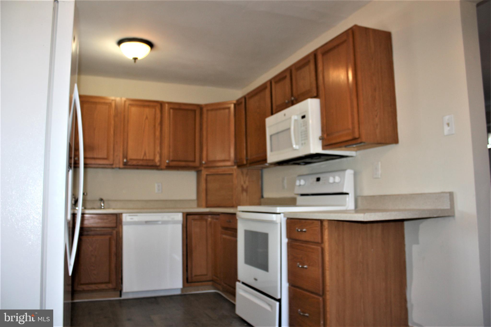 423 Happy Creek Road Front Royal, VA 22630 - Photo 10 of 48 a kitchen with white cabinets and white appliances