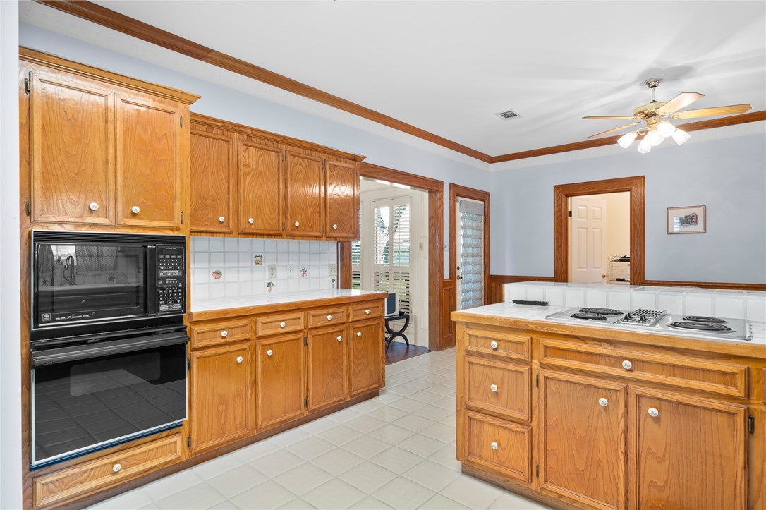 620 Colonial Drive Portland, TX 78374 - Photo 11 of 40 a kitchen with stainless steel appliances granite countertop a stove sink and cabinets