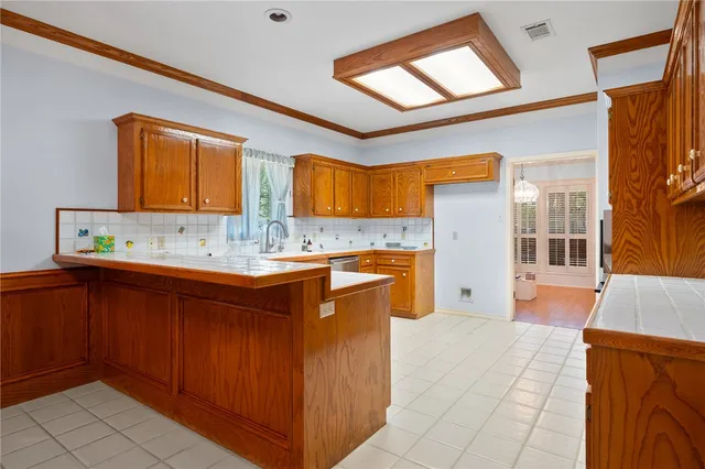 a large kitchen with stainless steel appliances granite countertop a sink and cabinets