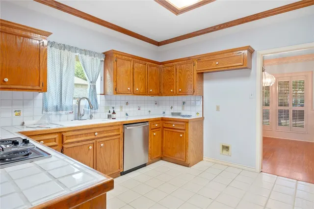 a kitchen with stainless steel appliances granite countertop a sink stove and cabinets