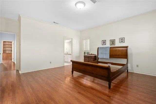 a living room with wooden floor and furniture