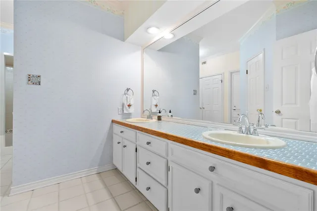 a bathroom with a double vanity sink and a mirror