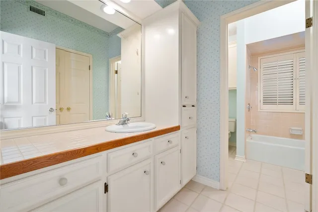 a bathroom with a sink a mirror and a bathtub