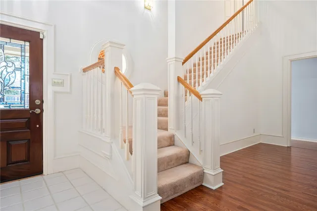 a view of entryway and hall with wooden floor