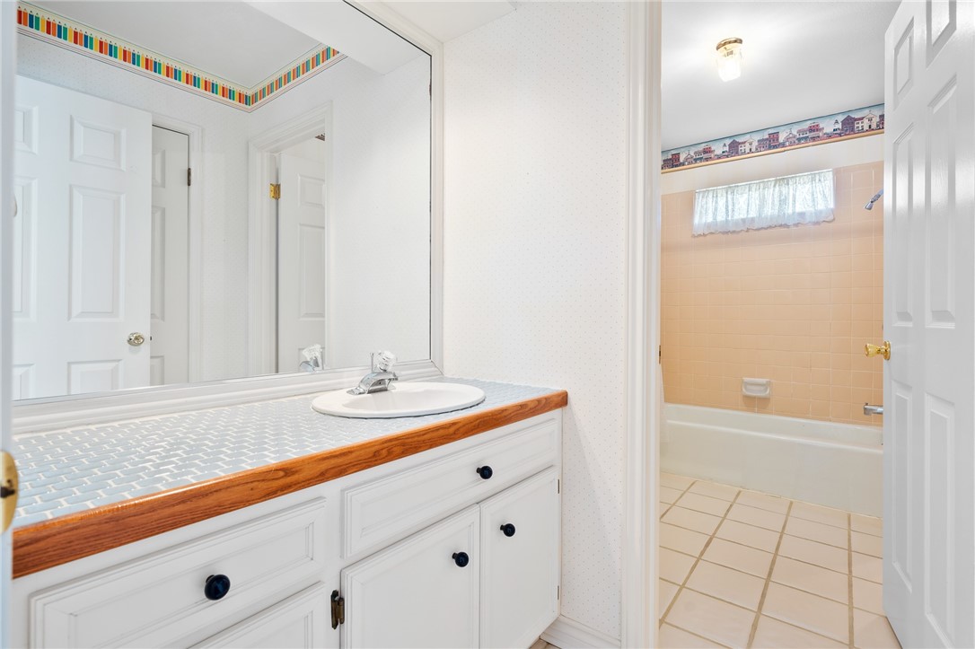 620 Colonial Drive Portland, TX 78374 - Photo 24 of 40 a bathroom with a sink a mirror and a shower