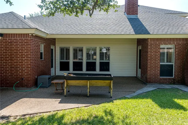 a view of a house with a large window and a yard