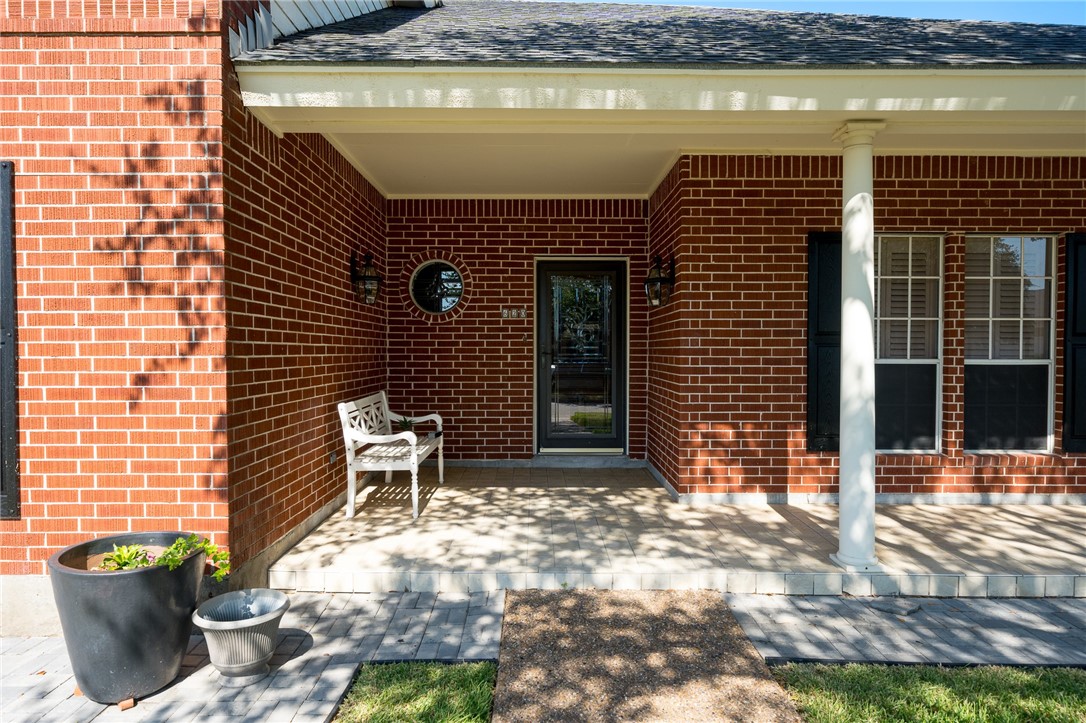 620 Colonial Drive Portland, TX 78374 - Photo 3 of 40 a brick house with potted plants in front of it