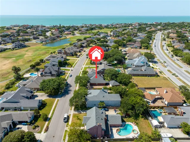 an aerial view of residential building and lake