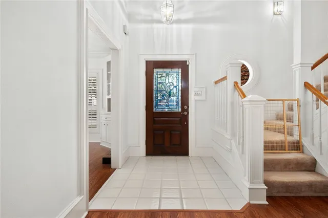 a view of a hallway with windows and cabinet
