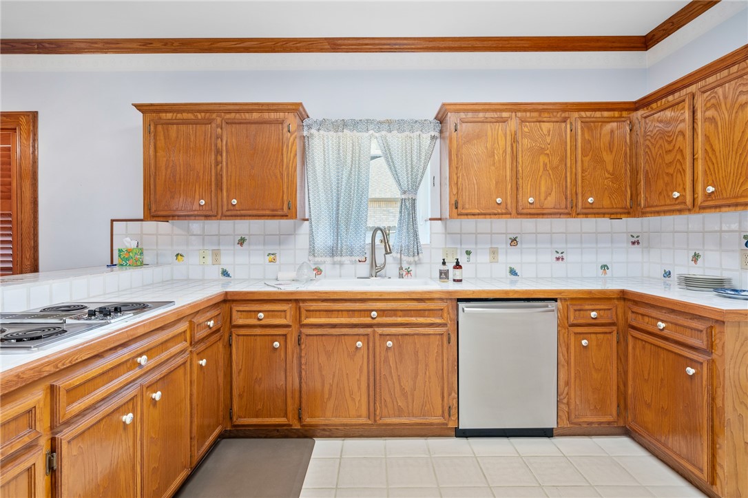 620 Colonial Drive Portland, TX 78374 - Photo 10 of 40 a kitchen with stainless steel appliances granite countertop a sink stove and cabinets
